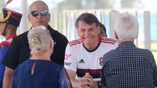 O presidente Jair Bolsonaro cumprimenta turistas no Alvorada